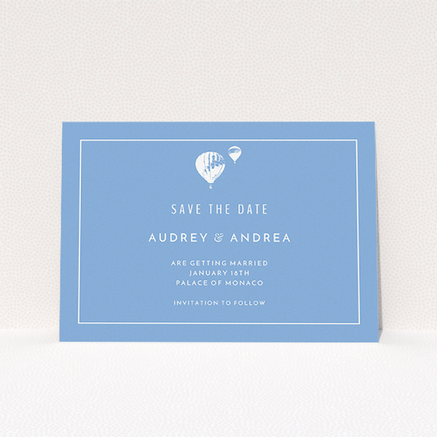 A wedding save the date card design named "Off and away". It is an A5 card in a landscape orientation. "Off and away" is available as a flat card, with tones of blue and white.