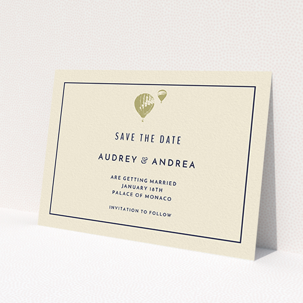 A wedding save the date card design titled 'Off and away'. It is an A6 card in a landscape orientation. 'Off and away' is available as a flat card, with tones of cream and gold.