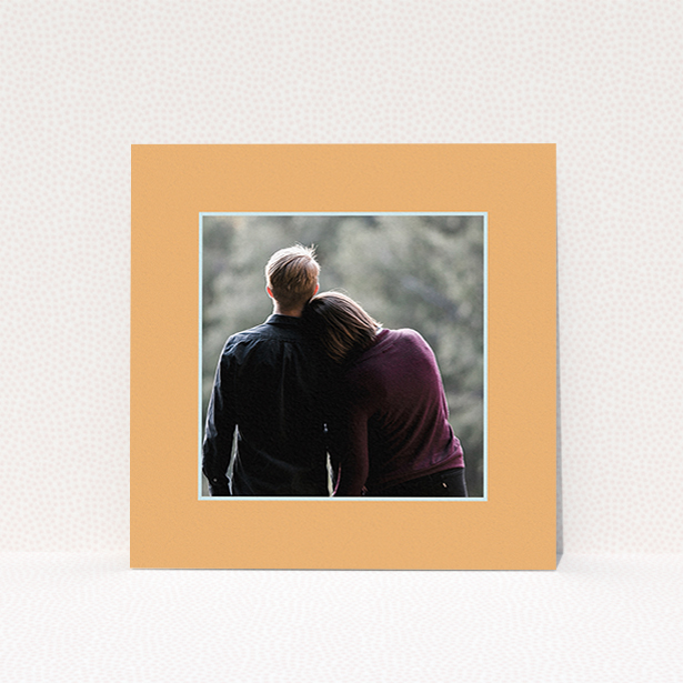 A wedding save the date card named "Orange Mint Photo Frame". It is a square (148mm x 148mm) card in a square orientation. It is a photographic wedding save the date card with room for 1 photo. "Orange Mint Photo Frame" is available as a flat card, with tones of orange and blue.