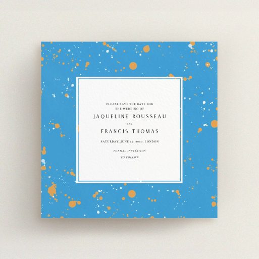 A wedding save the date card called "Orange Splatters". It is a square (148mm x 148mm) card in a square orientation. "Orange Splatters" is available as a flat card, with tones of light blue and orange.
