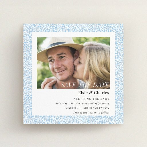 A wedding save the date card design named "Pastel flower border". It is a square (148mm x 148mm) card in a square orientation. It is a photographic wedding save the date card with room for 1 photo. "Pastel flower border" is available as a flat card, with tones of blue and white.