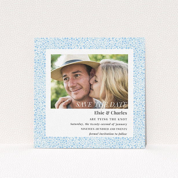 A wedding save the date card design named "Pastel flower border". It is a square (148mm x 148mm) card in a square orientation. It is a photographic wedding save the date card with room for 1 photo. "Pastel flower border" is available as a flat card, with tones of blue and white.