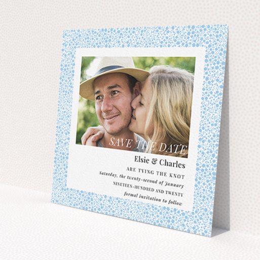 A wedding save the date card design named 'Pastel flower border'. It is a square (148mm x 148mm) card in a square orientation. It is a photographic wedding save the date card with room for 1 photo. 'Pastel flower border' is available as a flat card, with tones of blue and white.