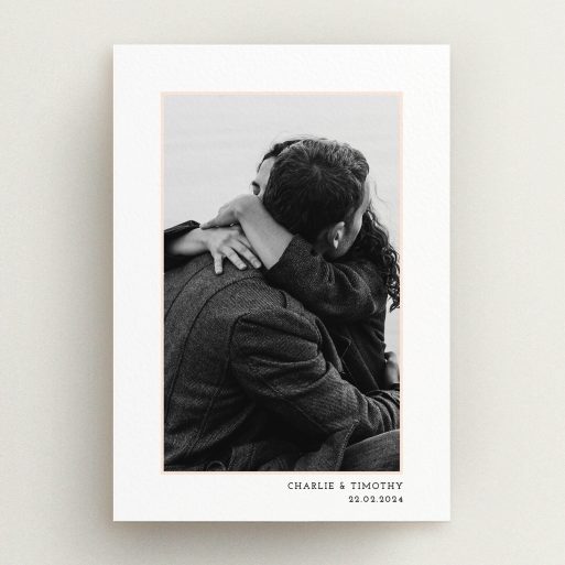 A wedding save the date card design named "Photo Centre". It is an A5 card in a portrait orientation. It is a photographic wedding save the date card with room for 1 photo. "Photo Centre" is available as a flat card, with tones of white and Pink.