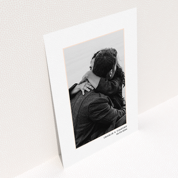 A wedding save the date card design named "Photo Centre". It is an A5 card in a portrait orientation. It is a photographic wedding save the date card with room for 1 photo. "Photo Centre" is available as a flat card, with tones of white and Pink.