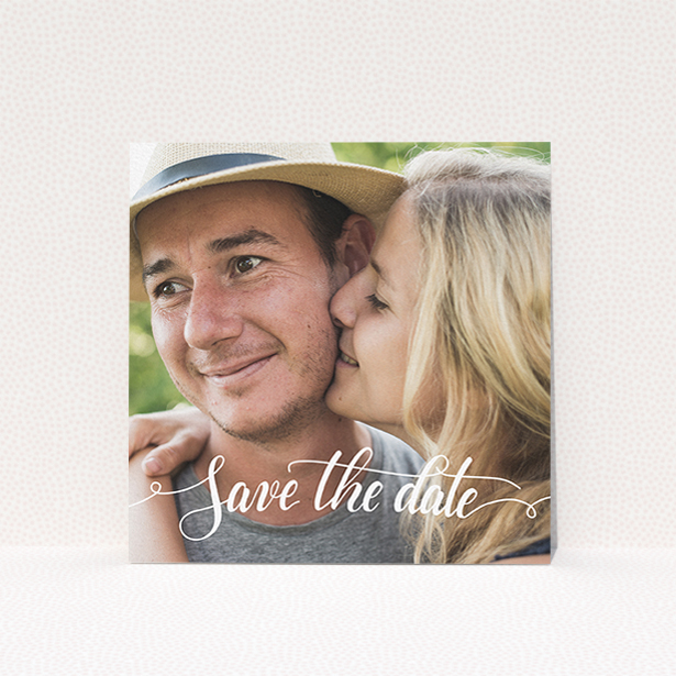 A wedding save the date card design named "Photo Typography". It is a square (148mm x 148mm) card in a square orientation. It is a photographic wedding save the date card with room for 1 photo. "Photo Typography" is available as a flat card, with mainly white colouring.