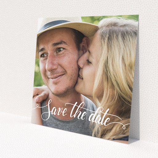A wedding save the date card design named 'Photo Typography'. It is a square (148mm x 148mm) card in a square orientation. It is a photographic wedding save the date card with room for 1 photo. 'Photo Typography' is available as a flat card, with mainly white colouring.