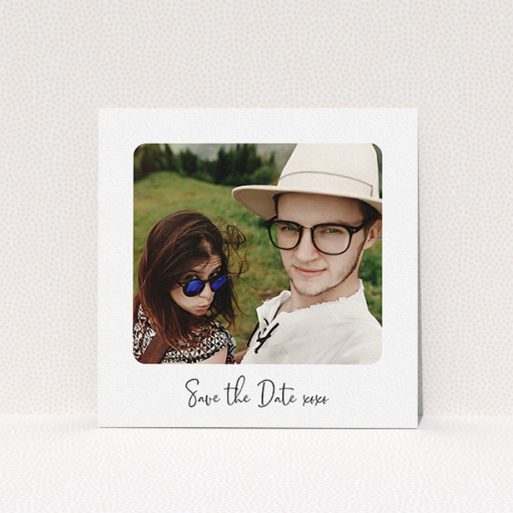 A wedding save the date card design called "Rounded Landscape Photo". It is a square (148mm x 148mm) card in a square orientation. It is a photographic wedding save the date card with room for 1 photo. "Rounded Landscape Photo" is available as a flat card, with mainly white colouring.