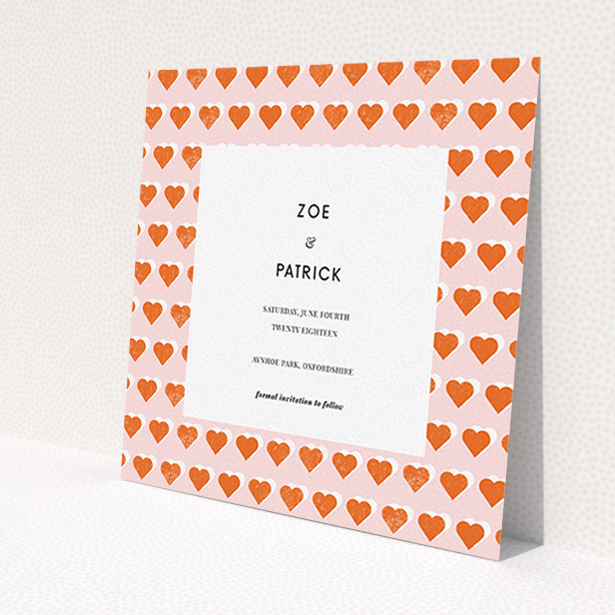 A wedding save the date card called "Rustic Hearts". It is a square (148mm x 148mm) card in a square orientation. "Rustic Hearts" is available as a flat card, with tones of pink and orange.