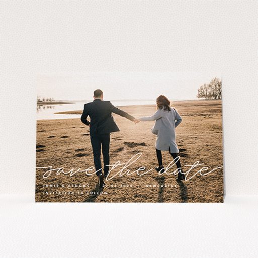 A wedding save the date card design titled "Save the Date Script". It is an A6 card in a landscape orientation. It is a photographic wedding save the date card with room for 1 photo. "Save the Date Script" is available as a flat card, with mainly white colouring.