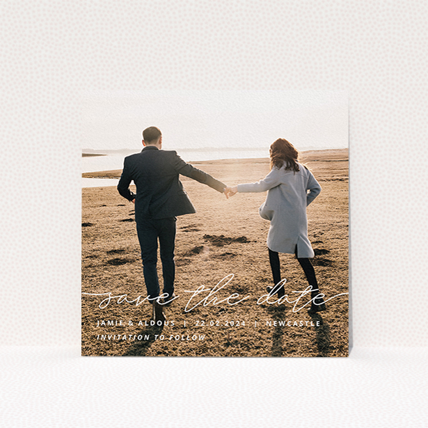 A wedding save the date card design called "Save the Date Script". It is a square (148mm x 148mm) card in a square orientation. It is a photographic wedding save the date card with room for 1 photo. "Save the Date Script" is available as a flat card, with mainly white colouring.