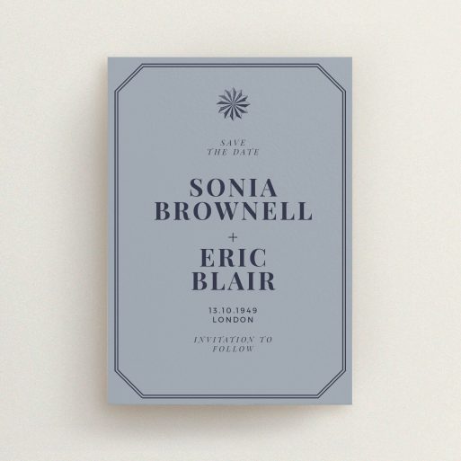 A wedding save the date card template titled "Shaded sundial". It is an A6 card in a portrait orientation. "Shaded sundial" is available as a flat card, with tones of dark grey and navy blue.