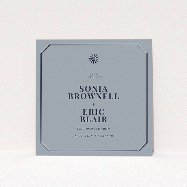 A wedding save the date card called "Shaded sundial". It is a square (148mm x 148mm) card in a square orientation. "Shaded sundial" is available as a flat card, with tones of dark grey and navy blue.
