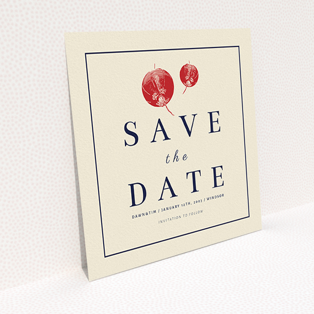 A wedding save the date card named "Shanghai Nights". It is a square (148mm x 148mm) card in a square orientation. "Shanghai Nights" is available as a flat card, with tones of cream and navy blue.