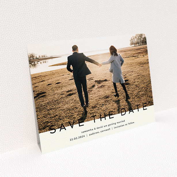 A wedding save the date card called "Simple Saving". It is an A5 card in a landscape orientation. It is a photographic wedding save the date card with room for 1 photo. "Simple Saving" is available as a flat card, with tones of cream and black.