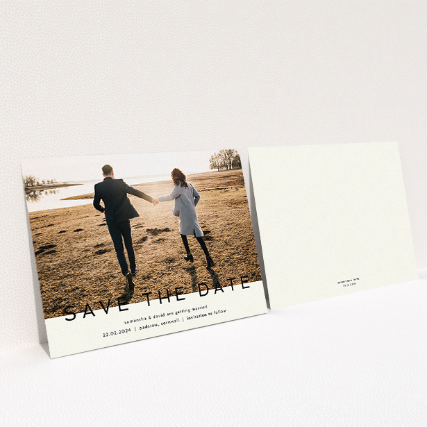 A wedding save the date card called "Simple Saving". It is an A5 card in a landscape orientation. It is a photographic wedding save the date card with room for 1 photo. "Simple Saving" is available as a flat card, with tones of cream and black.