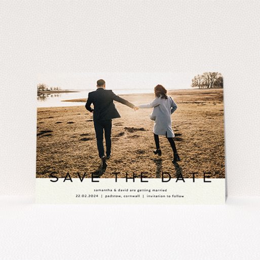 A wedding save the date card called "Simple Saving". It is an A6 card in a landscape orientation. It is a photographic wedding save the date card with room for 1 photo. "Simple Saving" is available as a flat card, with tones of cream and black.