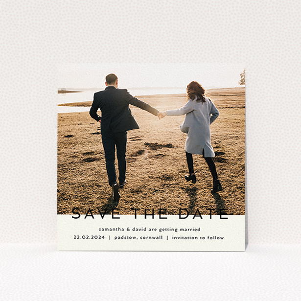 A wedding save the date card design called "Simple Saving". It is a square (148mm x 148mm) card in a square orientation. It is a photographic wedding save the date card with room for 1 photo. "Simple Saving" is available as a flat card, with tones of cream and black.