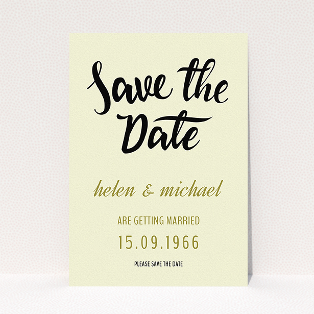 A wedding save the date card called "Simply Black Typography Pen". It is an A5 card in a portrait orientation. "Simply Black Typography Pen" is available as a flat card, with tones of cream, gold and black.