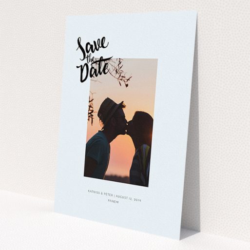 A wedding save the date card design titled 'Stamp Typography'. It is an A5 card in a portrait orientation. It is a photographic wedding save the date card with room for 1 photo. 'Stamp Typography' is available as a flat card, with mainly light blue colouring.