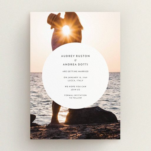 A wedding save the date card design called "Surrounded". It is an A5 card in a portrait orientation. It is a photographic wedding save the date card with room for 1 photo. "Surrounded" is available as a flat card, with mainly white colouring.