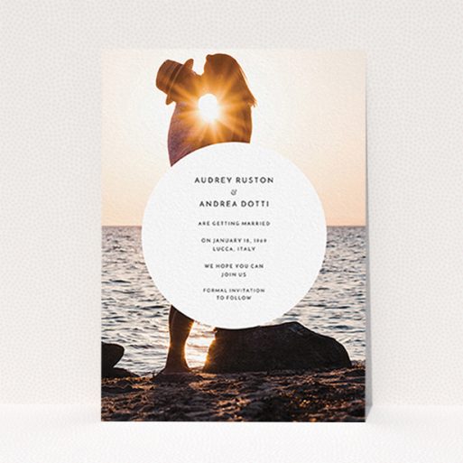 A wedding save the date card template titled "Surrounded". It is an A6 card in a portrait orientation. It is a photographic wedding save the date card with room for 1 photo. "Surrounded" is available as a flat card, with mainly white colouring.