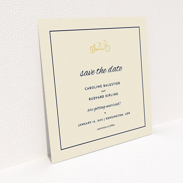 A wedding save the date card design titled "Tandem sheet". It is a square (148mm x 148mm) card in a square orientation. "Tandem sheet" is available as a flat card, with tones of cream and gold.