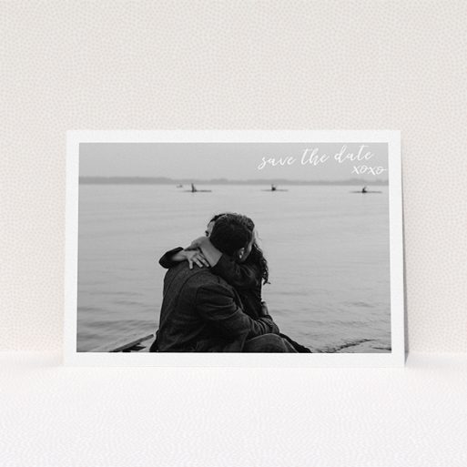 A wedding save the date card design called "Thick White Framed Photo". It is an A5 card in a landscape orientation. It is a photographic wedding save the date card with room for 1 photo. "Thick White Framed Photo" is available as a flat card, with mainly white colouring.