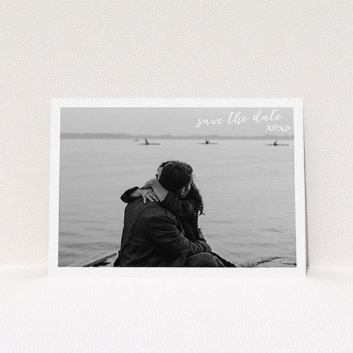 A wedding save the date card design called "Thick White Framed Photo". It is an A6 card in a landscape orientation. It is a photographic wedding save the date card with room for 1 photo. "Thick White Framed Photo" is available as a flat card, with mainly white colouring.