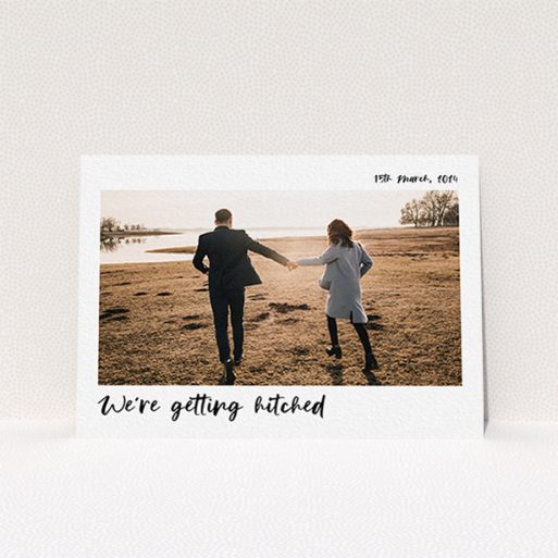 A wedding save the date card design called "Top and Bottom Photo". It is an A6 card in a landscape orientation. It is a photographic wedding save the date card with room for 1 photo. "Top and Bottom Photo" is available as a flat card, with mainly white colouring.