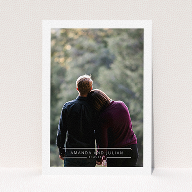 A wedding save the date card design called "Tramlines". It is an A6 card in a portrait orientation. It is a photographic wedding save the date card with room for 1 photo. "Tramlines" is available as a flat card, with mainly white colouring.