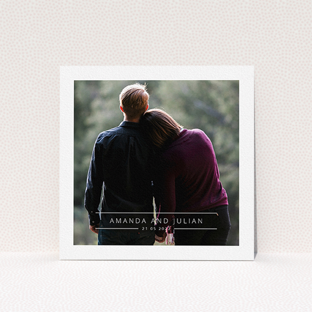 A wedding save the date card design titled "Tramlines". It is a square (148mm x 148mm) card in a square orientation. It is a photographic wedding save the date card with room for 1 photo. "Tramlines" is available as a flat card, with mainly white colouring.