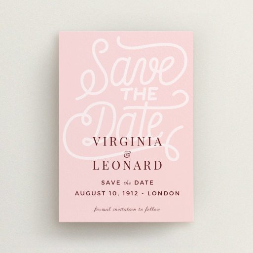 A wedding save the date card design titled "Typography Backing". It is an A6 card in a portrait orientation. "Typography Backing" is available as a flat card, with mainly pink colouring.