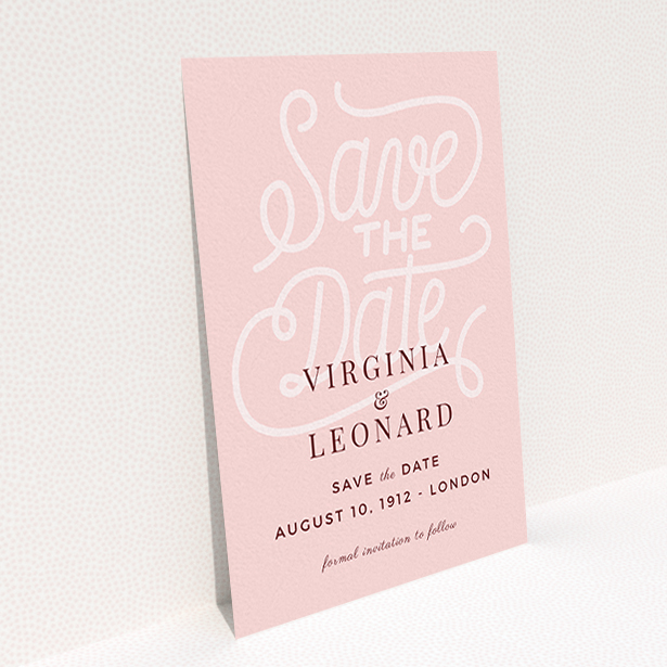 A wedding save the date card design titled "Typography Backing". It is an A6 card in a portrait orientation. "Typography Backing" is available as a flat card, with mainly pink colouring.