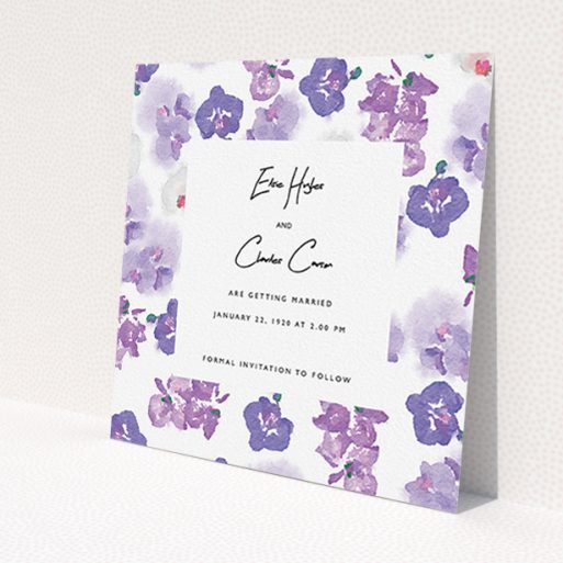 A wedding save the date card design named 'Violet Explosion'. It is a square (148mm x 148mm) card in a square orientation. 'Violet Explosion' is available as a flat card, with mainly purple/dark pink colouring.