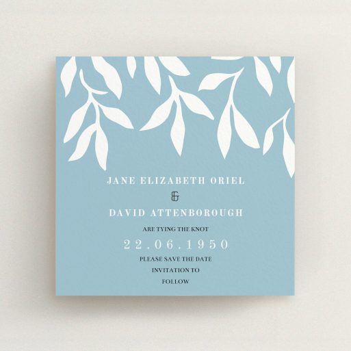 A wedding save the date card named "Winter bloom". It is a square (148mm x 148mm) card in a square orientation. "Winter bloom" is available as a flat card, with tones of blue and white.