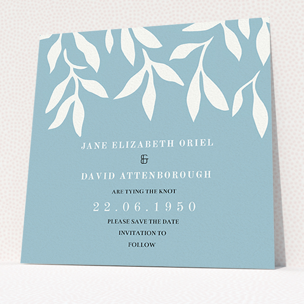 A wedding save the date card named "Winter bloom". It is a square (148mm x 148mm) card in a square orientation. "Winter bloom" is available as a flat card, with tones of blue and white.
