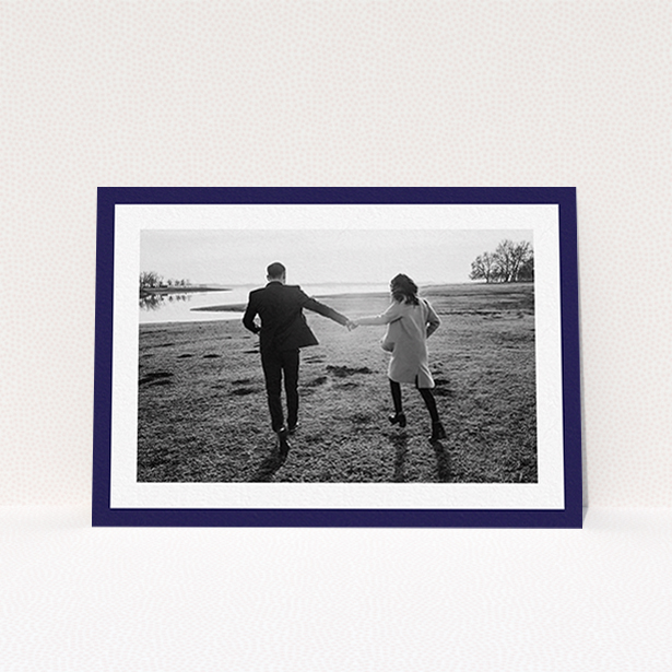 A wedding save the date design called "Classic Navy Photo Frame". It is an A6 save the date in a landscape orientation. It is a photographic wedding save the date with room for 1 photo. "Classic Navy Photo Frame" is available as a flat save the date, with tones of blue and white.