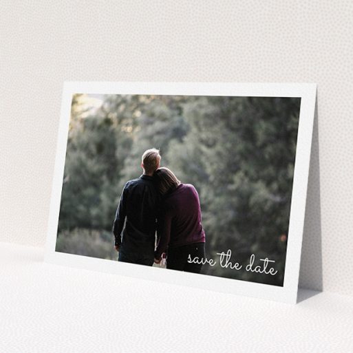 A wedding save the date template titled 'Date Saving Photo'. It is an A5 save the date in a landscape orientation. It is a photographic wedding save the date with room for 1 photo. 'Date Saving Photo' is available as a flat save the date, with mainly white colouring.