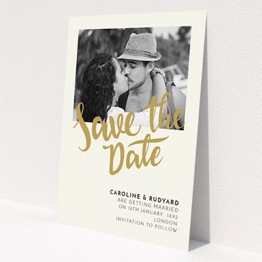 A wedding save the date design called 'Gold Typography Photo'. It is an A6 save the date in a portrait orientation. It is a photographic wedding save the date with room for 1 photo. 'Gold Typography Photo' is available as a flat save the date, with tones of cream and gold.