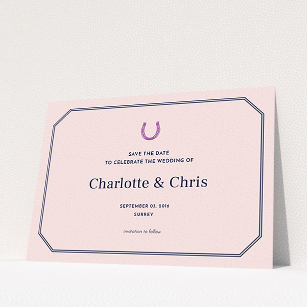 A wedding save the date named "Lucky horse shoe". It is an A6 save the date in a landscape orientation. "Lucky horse shoe" is available as a flat save the date, with mainly pink colouring.