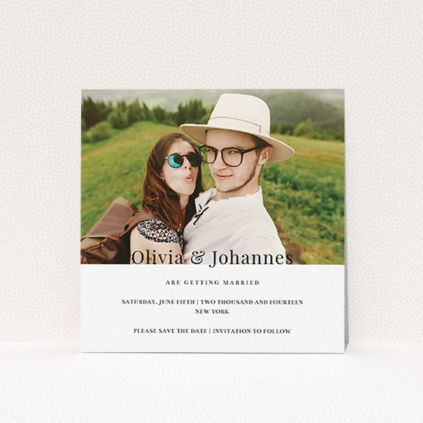 A wedding save the date template titled "On the fence". It is a square (148mm x 148mm) save the date in a square orientation. It is a photographic wedding save the date with room for 1 photo. "On the fence" is available as a flat save the date, with mainly white colouring.