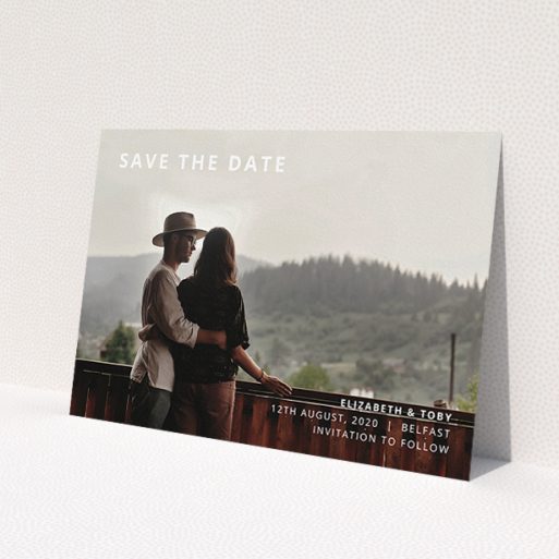 A wedding save the date design called 'Sans Serif'. It is an A5 save the date in a landscape orientation. It is a photographic wedding save the date with room for 1 photo. 'Sans Serif' is available as a flat save the date, with mainly white colouring.