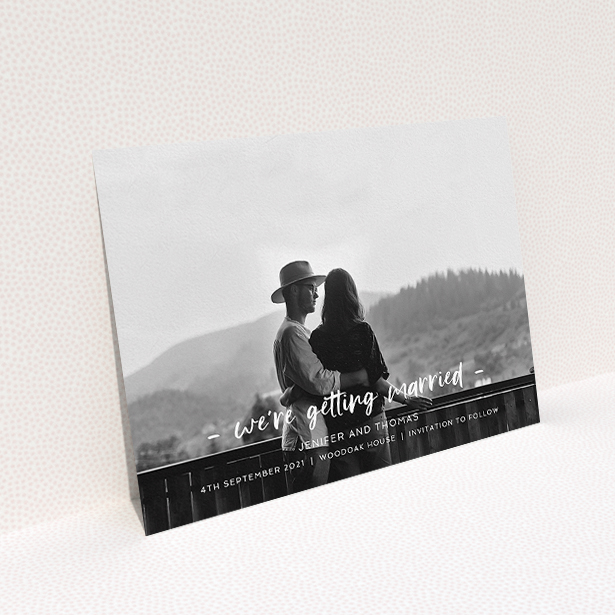A wedding save the date called "To the Point". It is an A5 save the date in a landscape orientation. It is a photographic wedding save the date with room for 1 photo. "To the Point" is available as a flat save the date, with mainly white colouring.