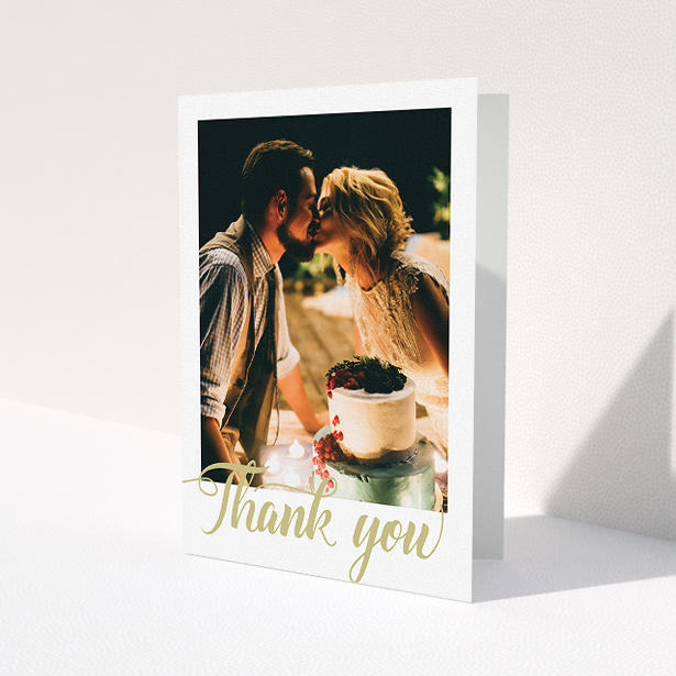 A wedding thank you card design called "A big thank you". It is an A5 card in a portrait orientation. It is a photographic wedding thank you card with room for 1 photo. "A big thank you" is available as a folded card, with tones of white and gold.