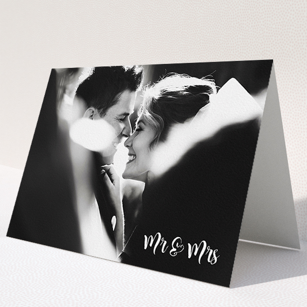 A wedding thank you card called "Black and White". It is an A5 card in a landscape orientation. It is a photographic wedding thank you card with room for 1 photo. "Black and White" is available as a folded card, with mainly white colouring.