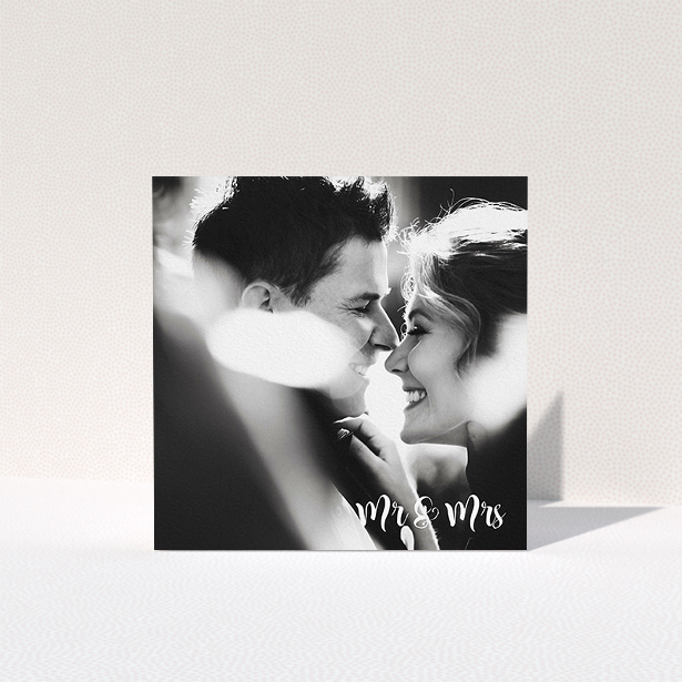 A wedding thank you card template titled "Black and White". It is a square (148mm x 148mm) card in a square orientation. It is a photographic wedding thank you card with room for 1 photo. "Black and White" is available as a folded card, with mainly white colouring.