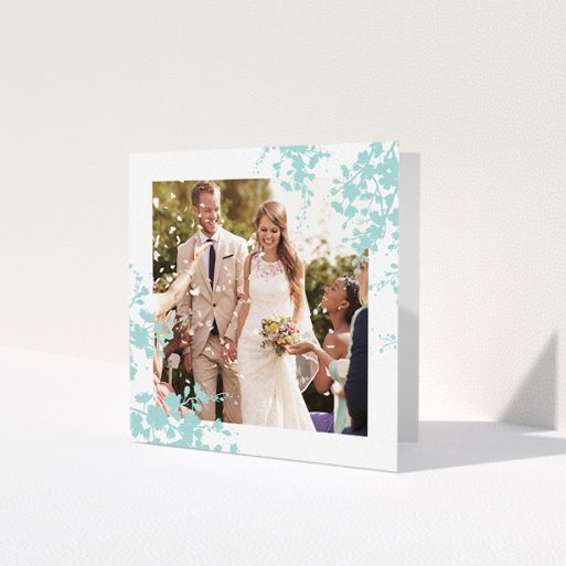 A wedding thank you card design named 'Blue blossom'. It is a square (148mm x 148mm) card in a square orientation. It is a photographic wedding thank you card with room for 1 photo. 'Blue blossom' is available as a folded card, with tones of blue and white.