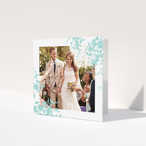 A wedding thank you card design named 'Blue blossom'. It is a square (148mm x 148mm) card in a square orientation. It is a photographic wedding thank you card with room for 1 photo. 'Blue blossom' is available as a folded card, with tones of blue and white.