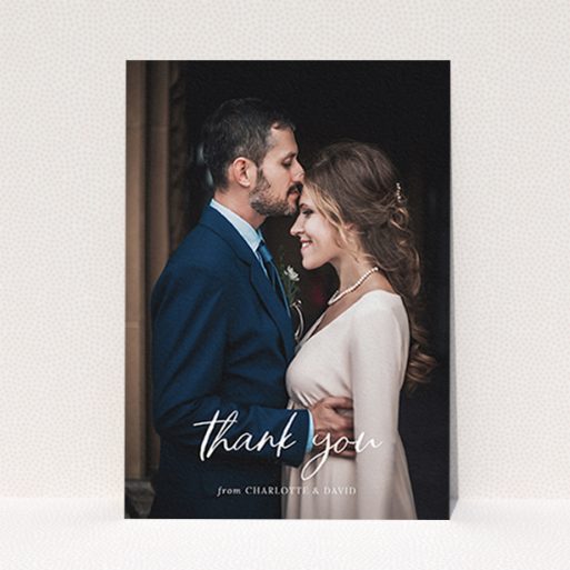 A wedding thank you card design named "Calligraphy Thanks". It is an A6 card in a portrait orientation. It is a photographic wedding thank you card with room for 1 photo. "Calligraphy Thanks" is available as a flat card, with mainly white colouring.